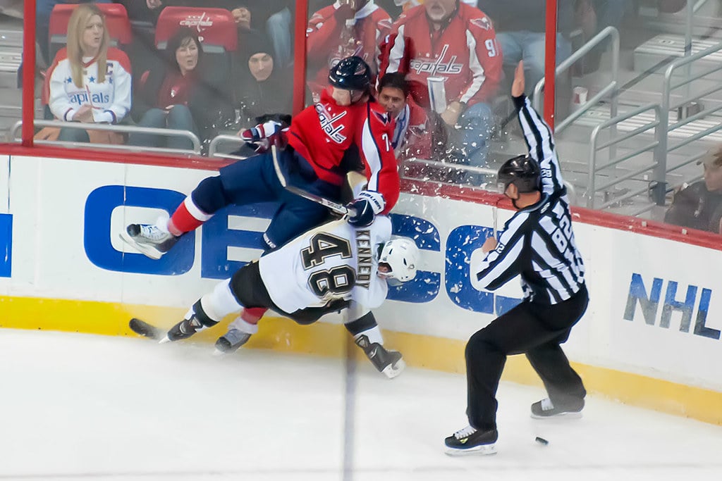 Washington Capitals defenseman John Carlson (#74) beats Pittsburgh Penguins forward Tyler Kennedy to the puck for an icing call during their NHL ice hockey game at Verizon Center.
